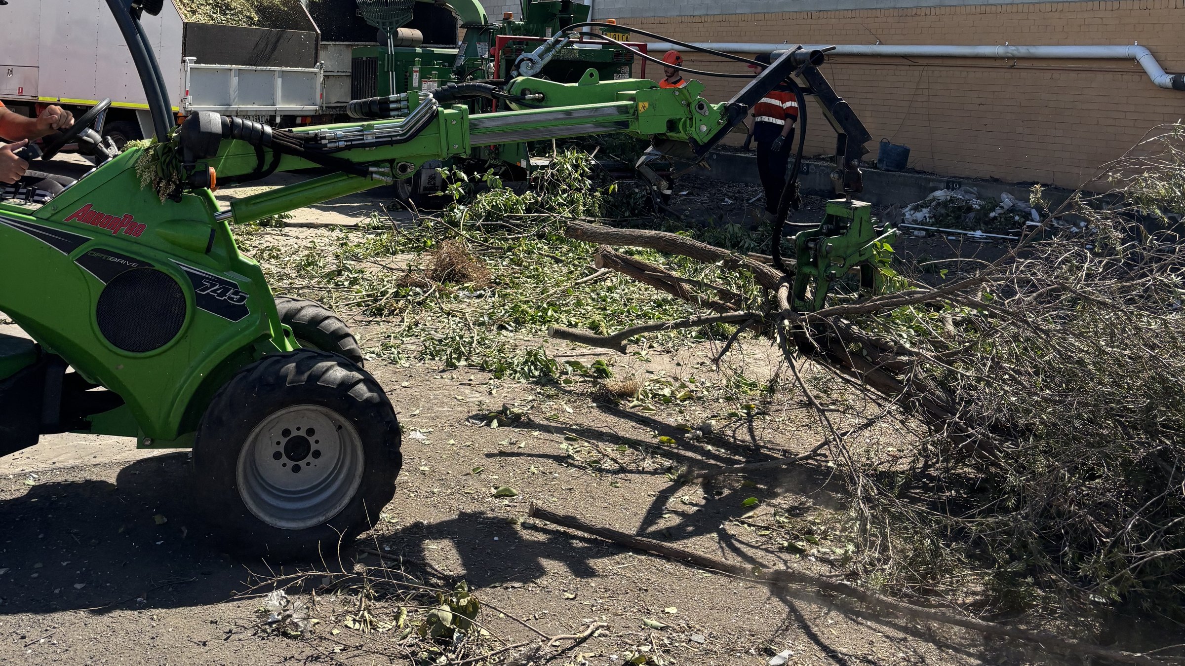 True Roots Avant loader clearing branches and green waste on a site