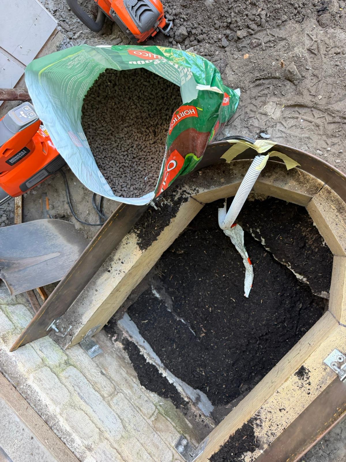 Premium soil mix going into a tree planting hole, Sydney