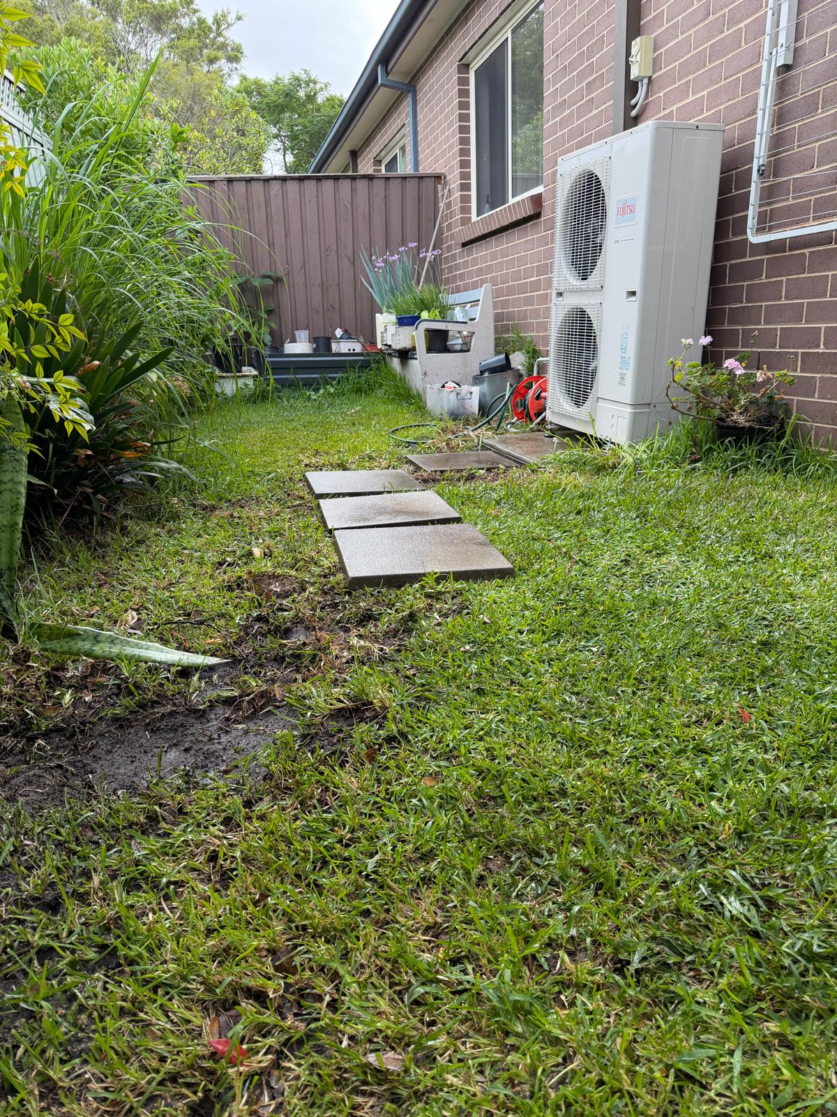 The same side path after the tree root was removed and the lawn and stepping stones put back